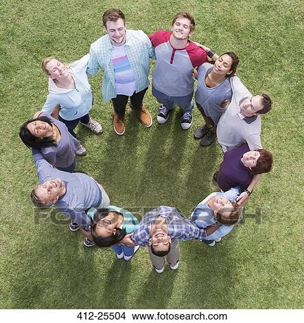 Team forming connected circle basking in sunny field View Large Photo Image Picture - Team forming connected circle basking in sunny field. Fotosearch