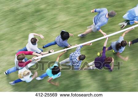 Team running and balancing pole on fingertips View Large Photo Image Stock Photo - Team running and balancing pole on fingertips. Fotosearch
