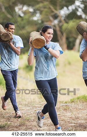 Woman running with log on boot camp obstacle course View Large Photo Image Stock Photography - Woman running with log on boot camp obstacle course. Fotosearch