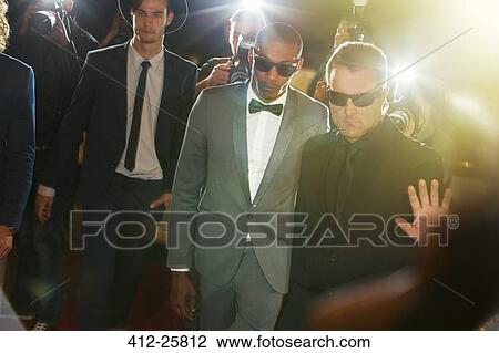 Bodyguard escorting celebrity arriving at event View Large Photo Image Stock Image - Bodyguard escorting celebrity arriving at event. Fotosearch