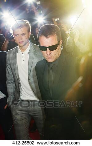 Bodyguard escorting celebrity at event View Large Photo Image Stock Image - Bodyguard escorting celebrity at event. Fotosearch