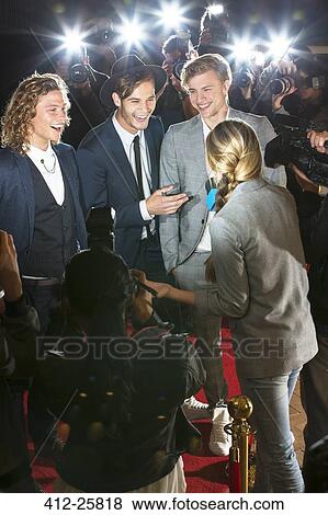 Stock Photo - Celebrities being interviewed and photographed by paparazzi at event. Fotosearch