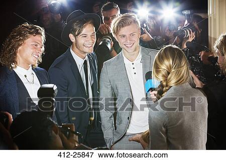 Stock Photo - Celebrities being interviewed and photographed by paparazzi at event. Fotosearch