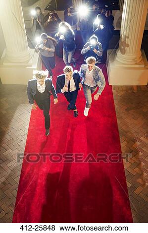 Celebrities running from paparazzi photographers at red carpet event View Large Photo Image Stock Photo - Celebrities running from paparazzi photographers at red carpet event. Fotosearch