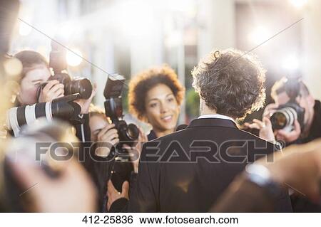 Stock Photograph - Celebrity being interviewed and photographed by paparazzi at event. Fotosearch