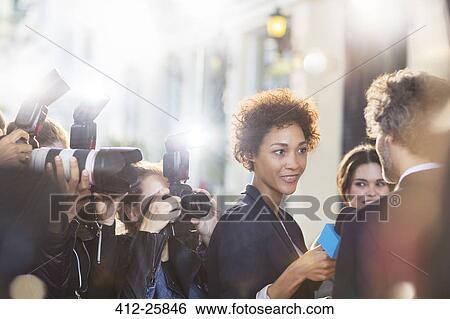 Celebrity being interviewed and photographed by paparazzi at event View Large Photo Image Stock Photograph - Celebrity being interviewed and photographed by paparazzi at event. Fotosearch