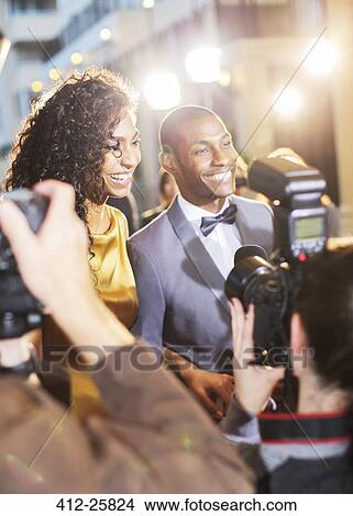 Celebrity couple being interviewed and photographed by paparazzi at event View Large Photo Image Picture - Celebrity couple being interviewed and photographed by paparazzi at event. Fotosearch