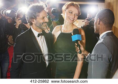 Celebrity couple being interviewed and photographed by paparazzi at event View Large Photo Image Stock Image - Celebrity couple being interviewed and photographed by paparazzi at event. Fotosearch