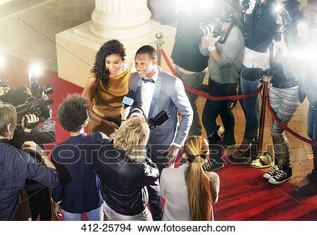 Picture - Celebrity couple being interviewed on red carpet. Fotosearch