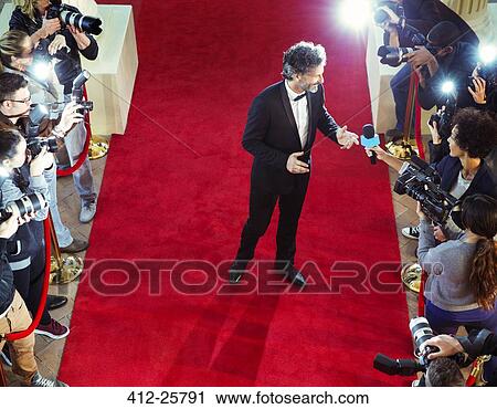Celebrity on red carpet being interviewed and photographed by paparazzi View Large Photo Image Stock Image - Celebrity on red carpet being interviewed and photographed by paparazzi. Fotosearch