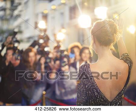 Celebrity waving at paparazzi photographers at event View Large Photo Image Stock Photograph - Celebrity waving at paparazzi photographers at event. Fotosearch