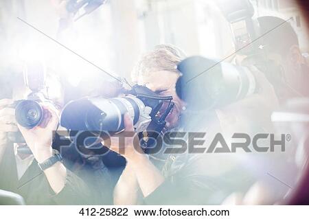 Close up of paparazzi photographers pointing cameras at event View Large Photo Image Stock Image - Close up of paparazzi photographers pointing cameras at event. Fotosearch