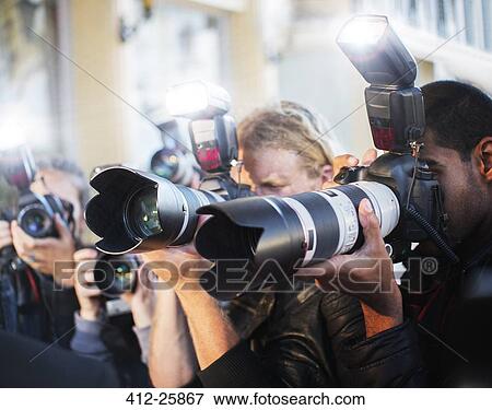 Close up of paparazzi photographers pointing cameras at event View Large Photo Image Stock Photo - Close up of paparazzi photographers pointing cameras at event. Fotosearch
