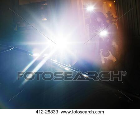 Lens flare flash of paparazzi photographers photographing at event View Large Photo Image Stock Image - Lens flare flash of paparazzi photographers photographing at event. Fotosearch