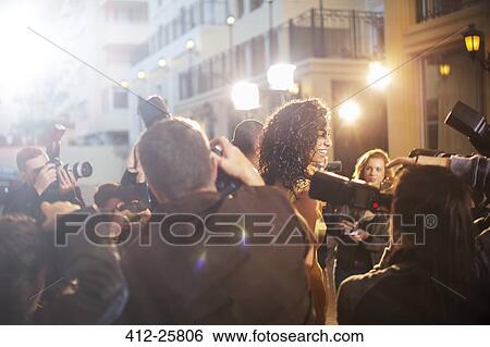 Stock Photograph - Paparazzi photographing celebrity at event. Fotosearch