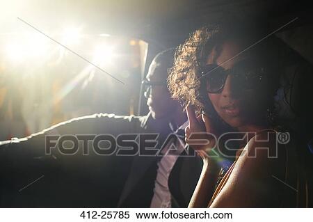 Portrait of celebrity couple in limousine arriving at event View Large Photo Image Stock Photography - Portrait of celebrity couple in limousine arriving at event. Fotosearch
