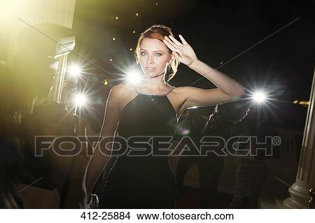 Portrait of confident celebrity being photographed by paparazzi at event View Large Photo Image Picture - Portrait of confident celebrity being photographed by paparazzi at event. Fotosearch