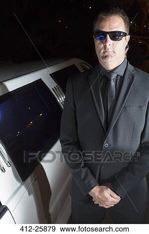 Portrait of serious bodyguard in sunglasses outside limousine at event View Large Photo Image Stock Photo - Portrait of serious bodyguard in sunglasses outside limousine at event. Fotosearch