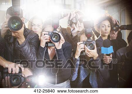 Portrait of serious paparazzi photographers pointing cameras View Large Photo Image Stock Image - Portrait of serious paparazzi photographers pointing cameras. Fotosearch