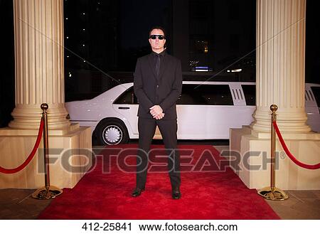 Serious bodyguard in sunglasses protecting red carpet at event View Large Photo Image Stock Image - Serious bodyguard in sunglasses protecting red carpet at event. Fotosearch