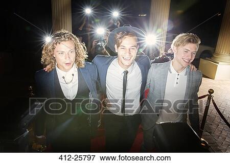 Smiling celebrities walking in a row at red carpet event View Large Photo Image Stock Photo - Smiling celebrities walking in a row at red carpet event. Fotosearch