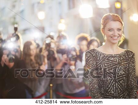 Smiling celebrity at event with photographing paparazzi in background View Large Photo Image Picture - Smiling celebrity at event with photographing paparazzi in background. Fotosearch
