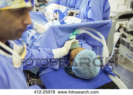 Anesthesiologist holding oxygen mask over patient’s face in operating room View Large Photo Image Stock Photo - Anesthesiologist holding oxygen mask over patient’s face in operating room. Fotosearch