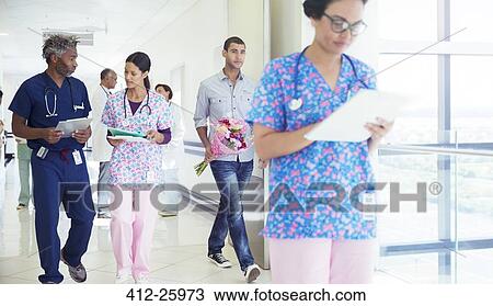 Doctor and nurse discussing medical record in hospital corridor View Large Photo Image Stock Image - Doctor and nurse discussing medical record in hospital corridor. Fotosearch