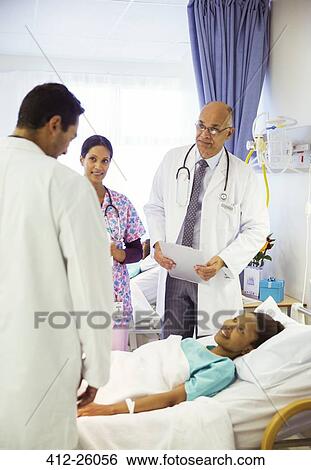 Doctors and nurse making rounds in hospital room View Large Photo Image Stock Photograph - Doctors and nurse making rounds in hospital room. Fotosearch