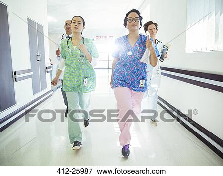Doctors and nurses running down hospital corridor View Large Photo Image Stock Photo - Doctors and nurses running down hospital corridor. Fotosearch
