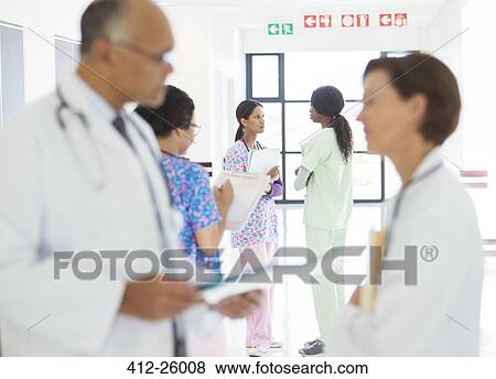 Doctors and nurses talking in hospital corridor View Large Photo Image Stock Photo - Doctors and nurses talking in hospital corridor. Fotosearch