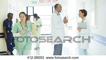 Doctors talking in hospital corridor View Large Photo Image Stock Image - Doctors talking in hospital corridor. Fotosearch