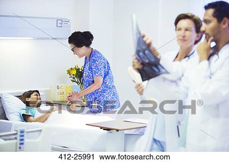 Nurse holding hands with patient in hospital room View Large Photo Image Stock Image - Nurse holding hands with patient in hospital room. Fotosearch