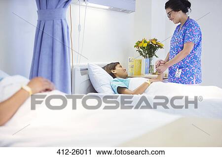 Nurse holding hands with patient in hospital room View Large Photo Image Stock Image - Nurse holding hands with patient in hospital room. Fotosearch