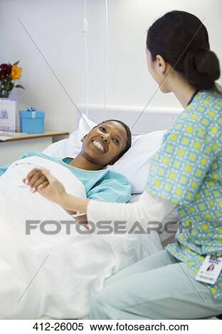 Nurse holding smiling patient’s hand in hospital room View Large Photo Image Stock Photography - Nurse holding smiling patient’s hand in hospital room. Fotosearch