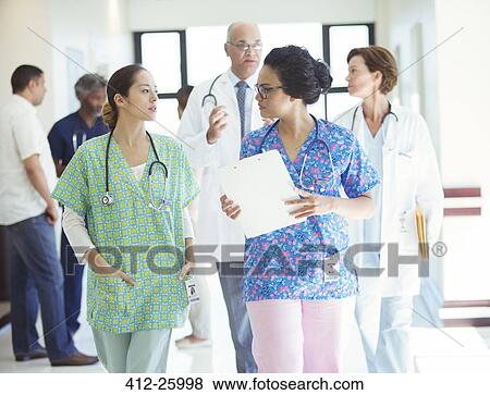 Nurses talking in hospital corridor View Large Photo Image Stock Photo - Nurses talking in hospital corridor. Fotosearch