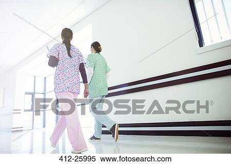 Nurses walking in hospital corridor View Large Photo Image Stock Photography - Nurses walking in hospital corridor. Fotosearch
