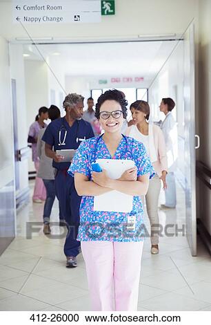Portrait of confident nurse with clipboard in hospital corridor View Large Photo Image Stock Image - Portrait of confident nurse with clipboard in hospital corridor. Fotosearch