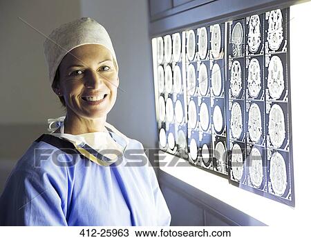 Portrait of smiling surgeon reviewing MRI scans View Large Photo Image Stock Image - Portrait of smiling surgeon reviewing MRI scans. Fotosearch