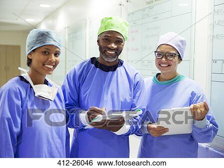 Portrait of smiling surgeons with clipboards in hospital View Large Photo Image Stock Photograph - Portrait of smiling surgeons with clipboards in hospital. Fotosearch