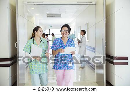 Stock Photo - Smiling nurses talking in hospital corridor. Fotosearch