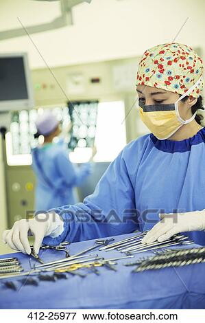 Surgeon arranging surgical scissors on tray in operating room View Large Photo Image Stock Photo - Surgeon arranging surgical scissors on tray in operating room. Fotosearch