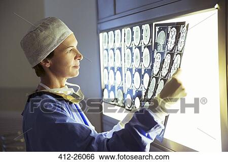 Stock Photograph - Surgeon reviewing MRI scans. Fotosearch