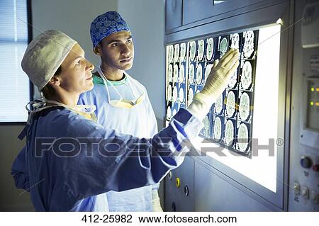 Surgeons discussing MRI scans View Large Photo Image Stock Image - Surgeons discussing MRI scans. Fotosearch
