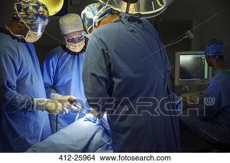 Surgeons performing surgery in operating room View Large Photo Image Picture - Surgeons performing surgery in operating room. Fotosearch
