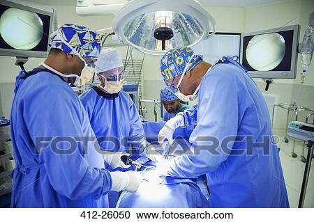 Surgeons performing surgery in operating room View Large Photo Image Stock Image - Surgeons performing surgery in operating room. Fotosearch