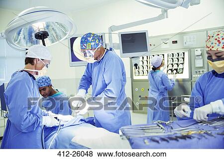 Surgeons performing surgery in operating room View Large Photo Image Stock Photo - Surgeons performing surgery in operating room. Fotosearch