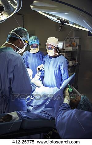 Surgeons performing surgery in operating room View Large Photo Image Stock Photography - Surgeons performing surgery in operating room. Fotosearch