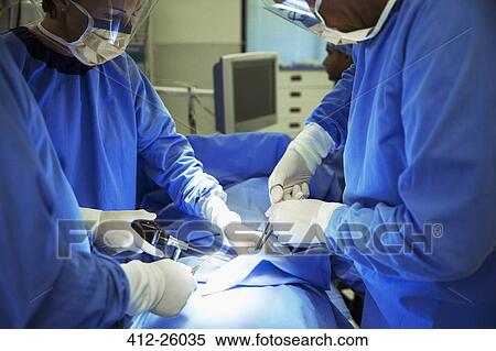 Surgeons performing surgery in operating room View Large Photo Image Stock Photography - Surgeons performing surgery in operating room. Fotosearch