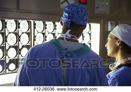 Surgeons reviewing and discussing MRI scans View Large Photo Image Stock Photograph - Surgeons reviewing and discussing MRI scans. Fotosearch